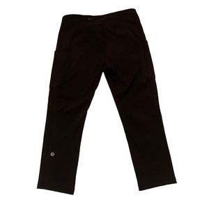 Black Lululemon crop yoga pants, high rise with hidden side pockets size 8